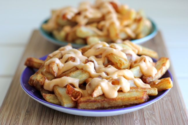 Garlic Cheese Fries - Perfectly double-fried french fries smothered in a garlic cheese sauce that can be made in 5 minutes!