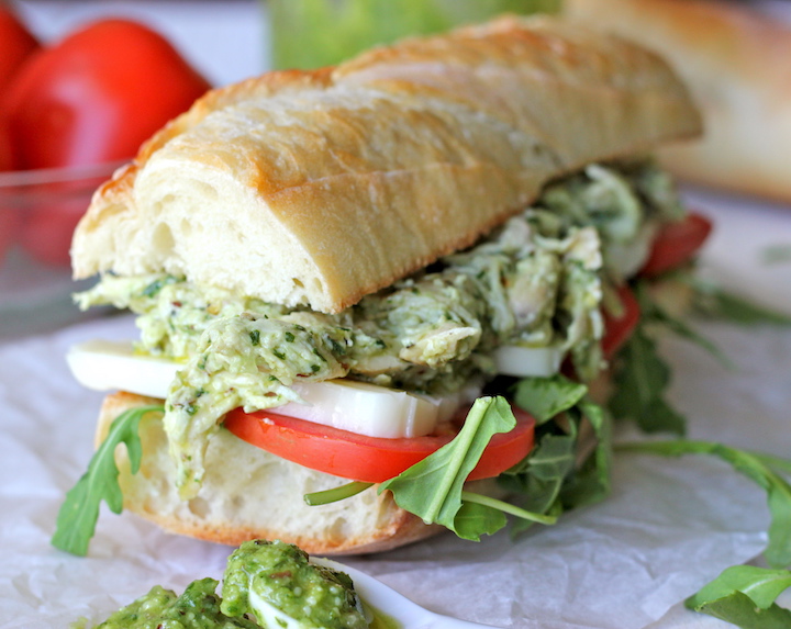 Chicken pesto served on a fresh baguette with arugula, sliced tomatoes and mozzarella.