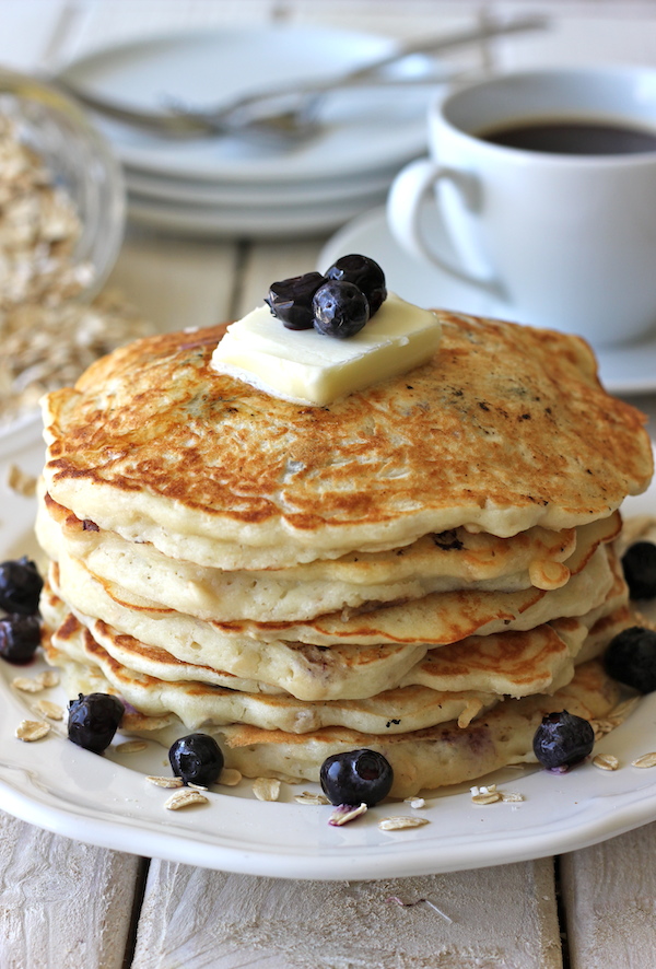 Blueberry Oatmeal Yogurt Pancakes - Start your mornings off right with these light and healthy pancakes loaded with juicy blueberries!