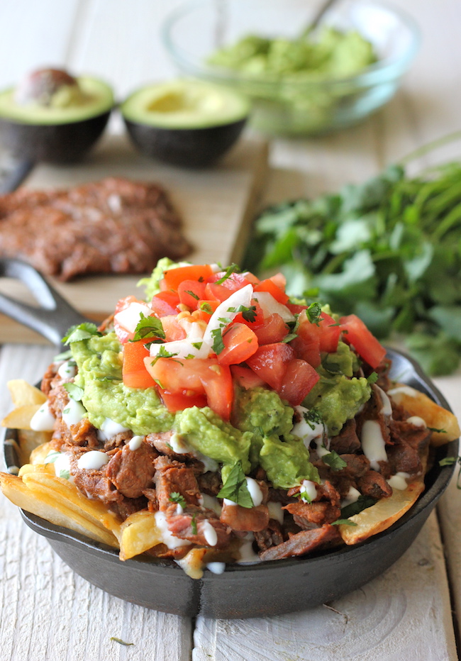 Carne Asada Fries - These french fries are loaded with carne asada, guacamole, pico de gallo and sour cream!