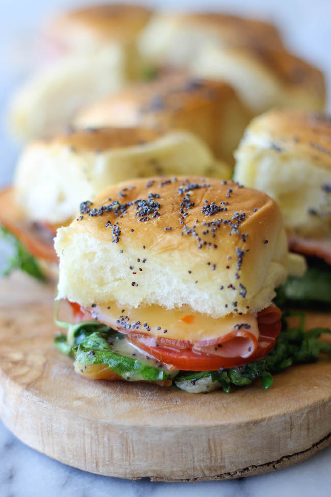 Baked Ham and Cheese Sliders - These sliders are popped in the oven until they're completely buttery and oozing with melted cheese!