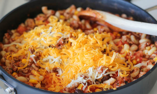 One Pot Mexican Skillet Pasta - This Mexican-inspired pasta dish can be made in 30 minutes or less. Even the pasta gets cooked right in the pot!