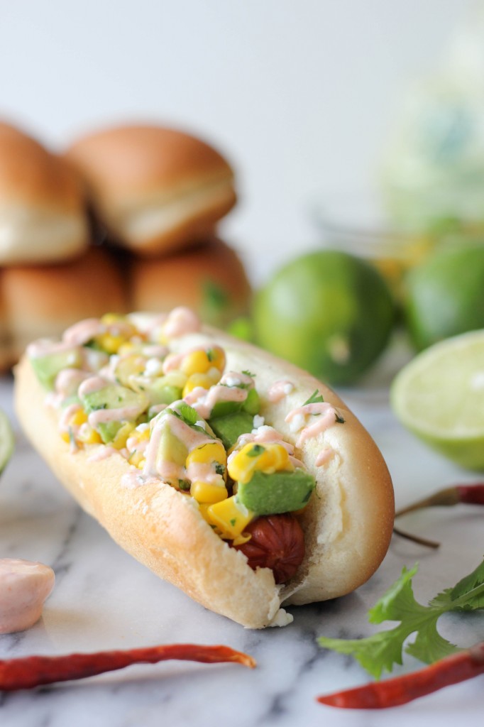 Mexican Hot Dogs with Chipotle Cream - These grilled hot dogs are topped with an avocado corn salsa and a Greek yogurt chipotle drizzle!