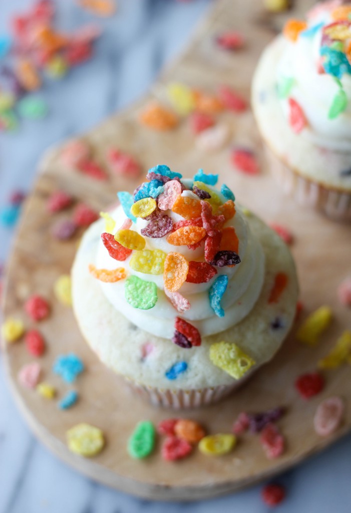 Fruity Pebble Cupcakes - Funfetti cupcakes topped with a vanilla buttercream frosting and sprinkled with colorful Fruity Pebbles!