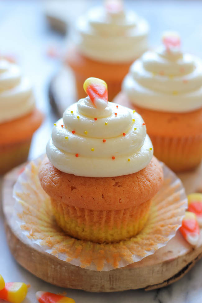 Candy Corn Cupcakes - These simple vanilla cupcakes can easily be dressed up to resemble the layers of candy corn goodness!
