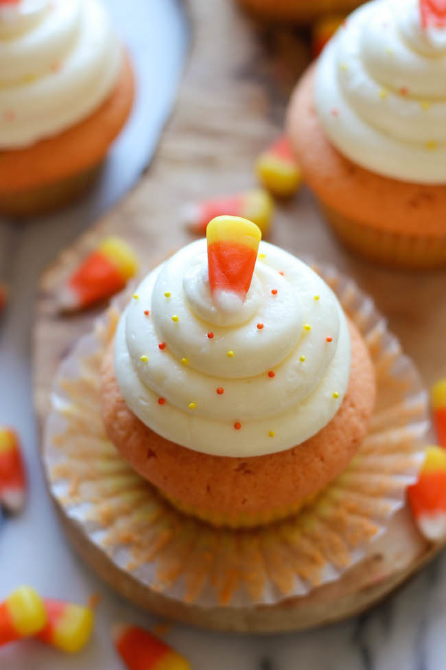 Candy Corn Cupcakes - These simple vanilla cupcakes can easily be dressed up to resemble the layers of candy corn goodness!