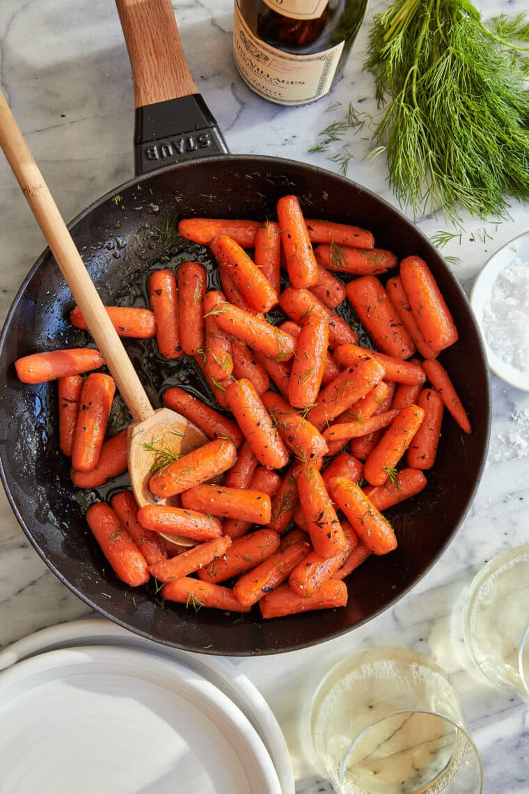 Honey Glazed Baby Carrots - The sweet + sticky honey glaze makes these baby carrots completely irresistible in this easy 15-minute side dish!