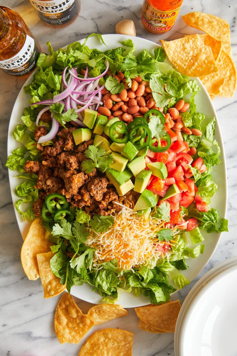 Taco Salad - With taco-seasoned ground beef, crisp lettuce, beans, avocado and cheese! Top with a dollop of sour cream. So quick, so good!