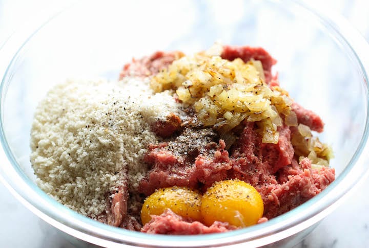 Raw ingredients for Swedish Meat Balls in a glass mixing bowl.