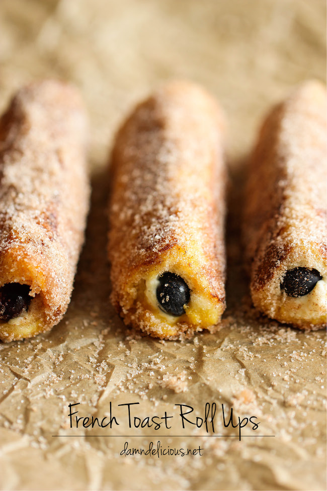 Blueberry French Toast Roll Ups - A fun twist on French toast stuffed with cream cheese and blueberries, tossed in cinnamon sugar goodness!