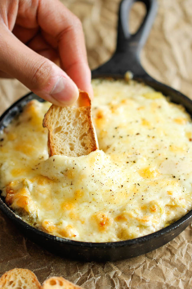 Crab and Artichoke Dip - This crowd-pleasing dip comes together in just 10 minutes, and it is baked to absolute cheesy perfection!