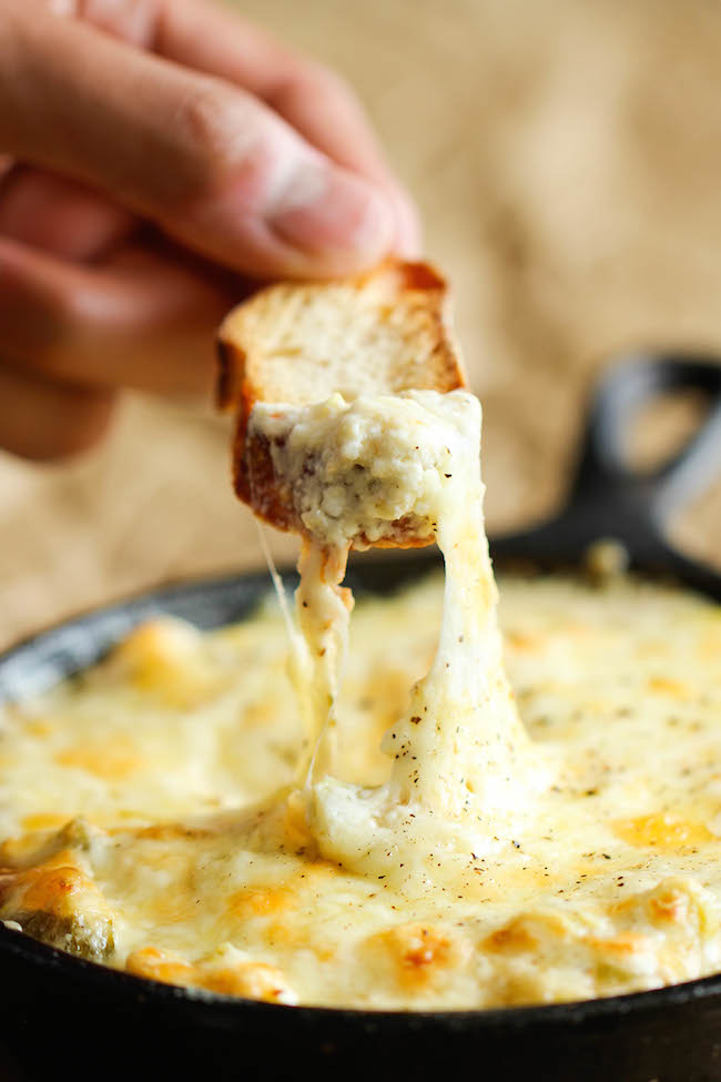 Crab and Artichoke Dip - This crowd-pleasing dip comes together in just 10 minutes, and it is baked to absolute cheesy perfection!