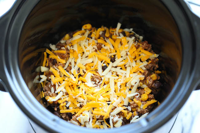 Slow Cooker Enchilada Stack - Simply turn on your crockpot and forget all about it until you have the cheesiest and creamiest enchiladas ever! It's so easy!