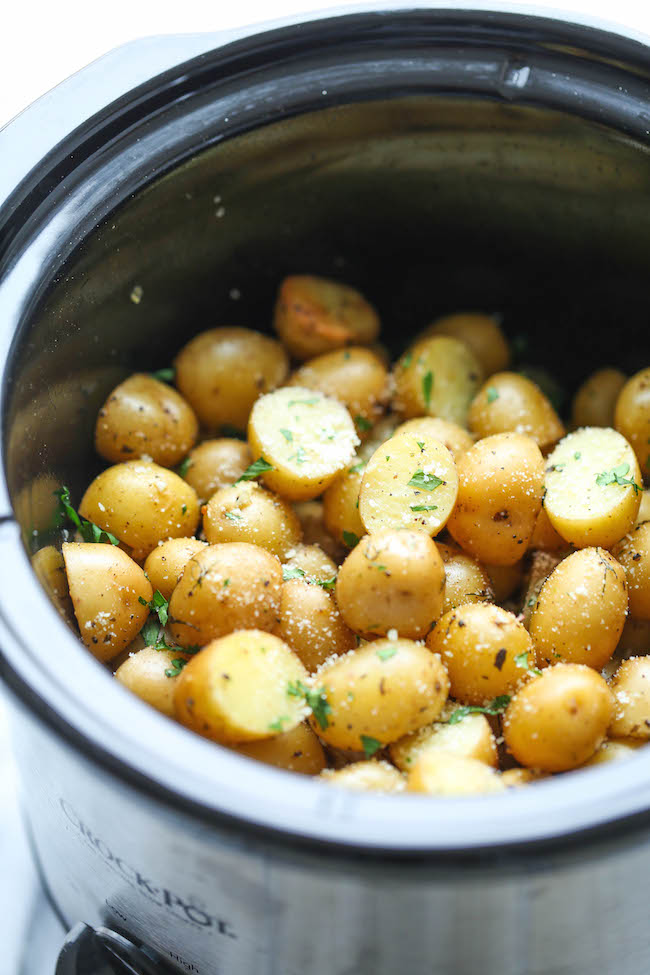 Slow Cooker Garlic Parmesan Potatoes - Crisp-tender potatoes with garlicky parmesan goodness. It's the easiest side dish you will ever make in the crockpot!