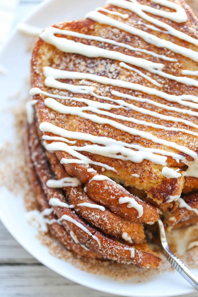 Churro French Toast - The most amazing, most buttery French toast you will ever have, coated in cinnamon sugar and drizzled with an epic cream cheese glaze!