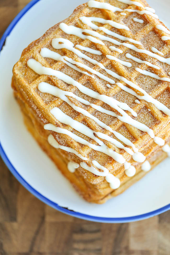 Pumpkin Churro Waffles - Light, fluffy, melt-in-your mouth pumpkin waffles coated in buttery cinnamon sugar and drizzled with a cream cheese glaze! Amazing.