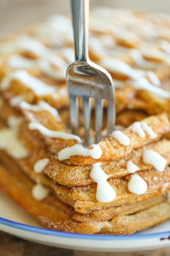 Pumpkin Churro Waffles - Light, fluffy, melt-in-your mouth pumpkin waffles coated in buttery cinnamon sugar and drizzled with a cream cheese glaze! Amazing.