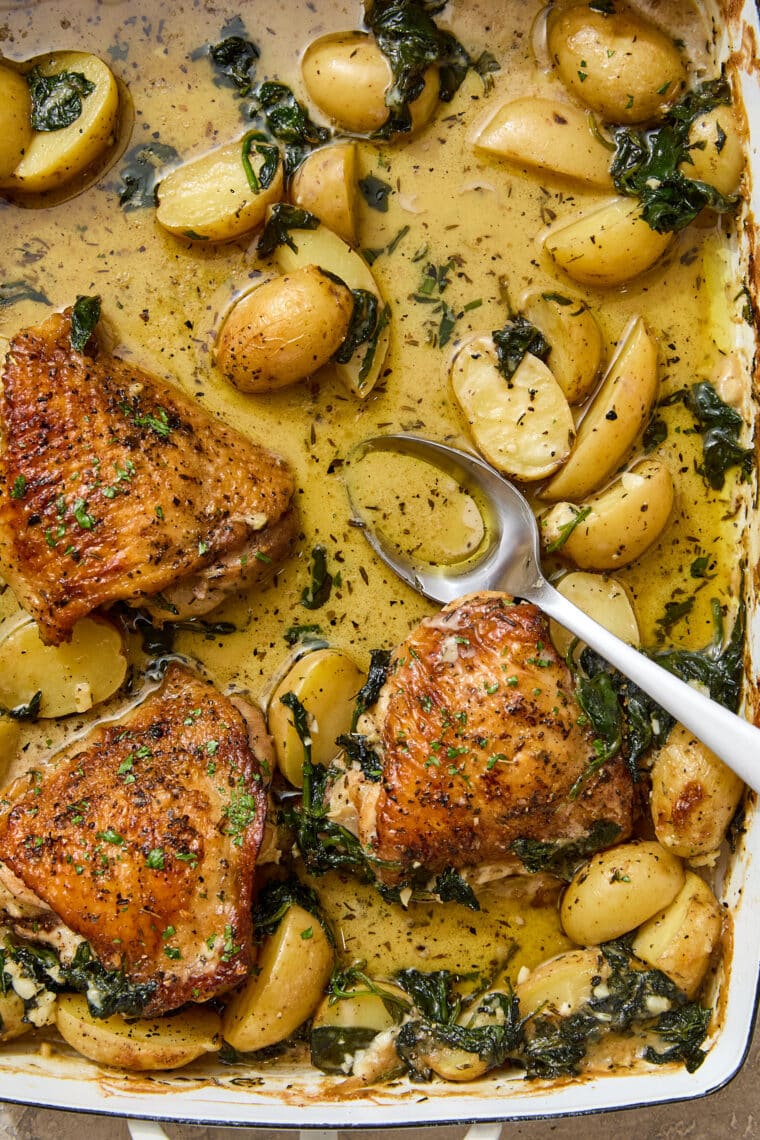 Chicken and Potatoes with Garlic Parmesan Cream Sauce - A complete meal in one! Baked crisp-tender chicken with potatoes and spinach, so good!