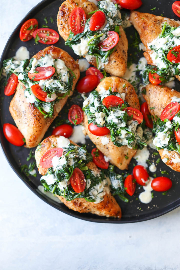 Chicken Florentine with White Wine Cream Sauce - Juicy chicken breasts topped with fresh spinach, tomatoes and a creamy white sauce that is AH-MAZING!