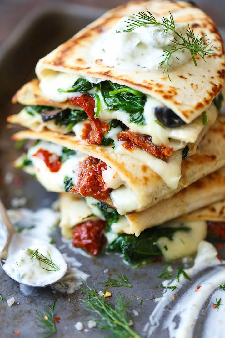 Greek Quesadillas - All the best Greek favors come together in this EPIC cheesy quesadilla, topped with an easy homemade Greek yogurt tzatziki sauce!