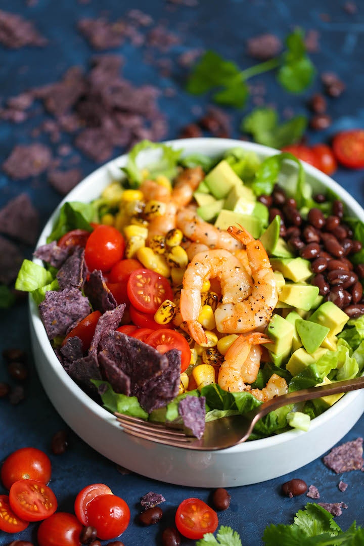 Shrimp and Avocado Salad - This tastes just like shrimp taco in salad form! Loaded with tomatoes, corn, black beans, cilantro, avocado and crushed tortilla chips with the very best cilantro lime dressing ever!