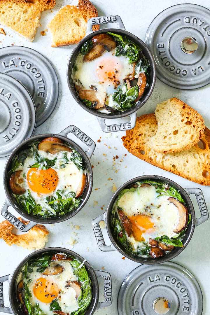 Baked Eggs with Mushrooms and Spinach - Easy peasy individual baked eggs with garlicky sautéed mushrooms and wilted spinach. Healthy, hearty and quick! Serve for breakfast, lunch or dinner with lots of buttered toast! Great for guests or for individual servings.