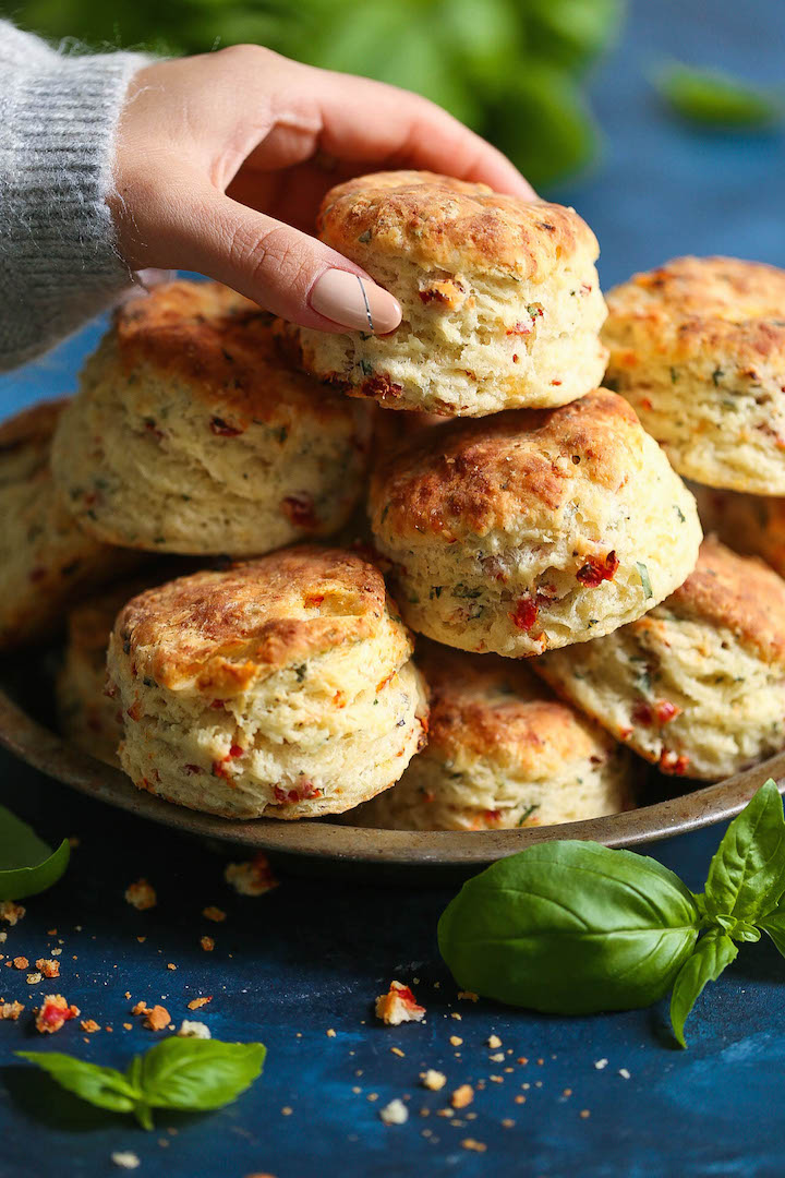 Sun Dried Tomato Parmesan Biscuits - These savory biscuits are simply irresistible! Warm, flaky, buttery and packed with so much flavor from the sun dried tomatoes, fresh basil, and Parmesan cheese. Just try to stop at one of these!