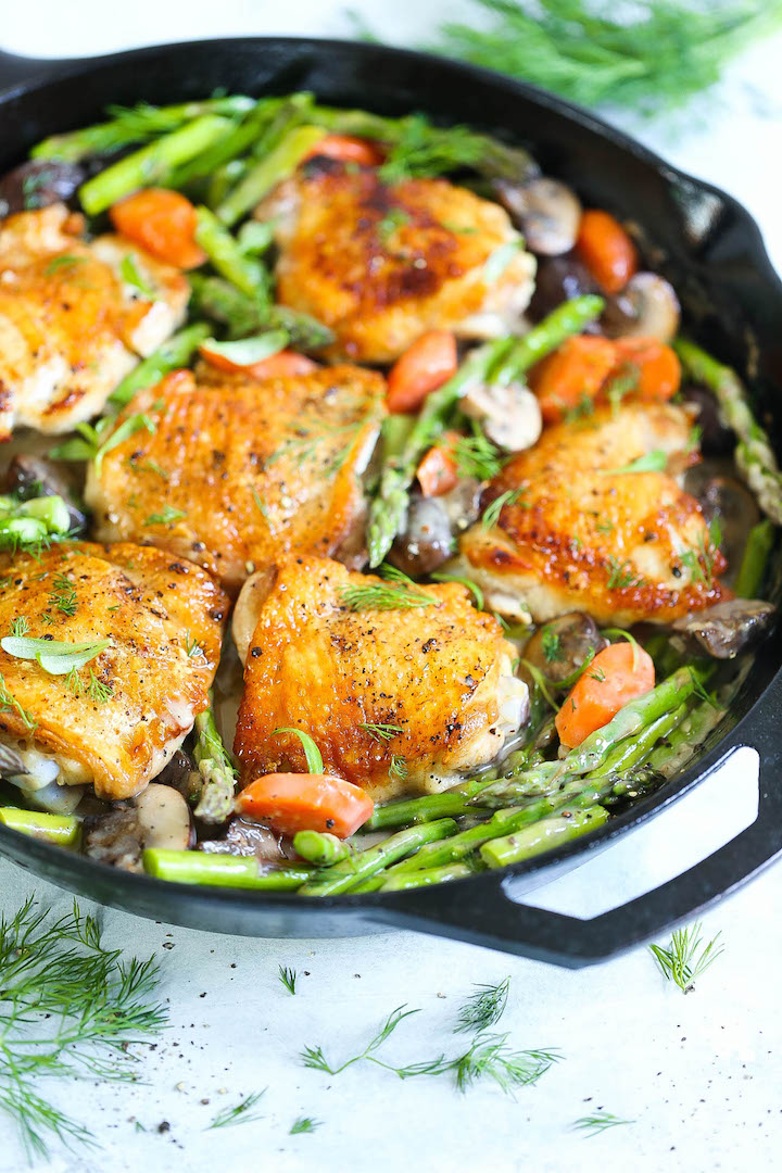 Skillet Chicken with Creamy Spring Vegetables - One pan winner winner chicken dinner! The chicken comes out amazingly crisp tender with carrots, mushrooms and asparagus all cooked in the best herb cream sauce!