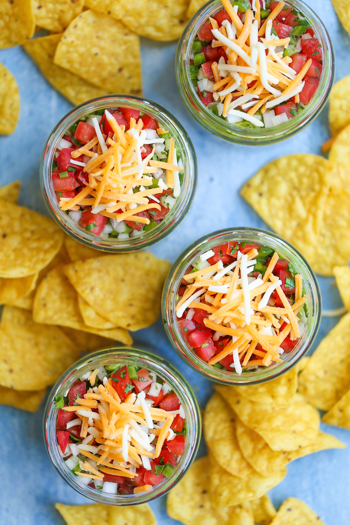 5-Layer Mason Jar Taco Dip - Everyone’s favorite dip in mason jar form! Everything is layered in individual jars so it makes for the easiest serving! Loaded with taco beef, refried beans, guacamole, pico de gallo, and cheese!