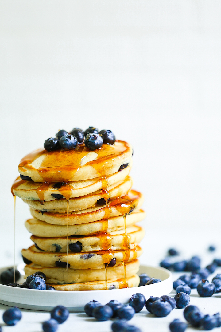 Blueberry Sour Cream Pancakes - The most amazing light, fluffy, melt-in-your-mouth pancakes! It's restaurant-quality pancakes right at home! They're so buttery, studded with the juiciest blueberries. Just try stopping at one stack of pancakes!