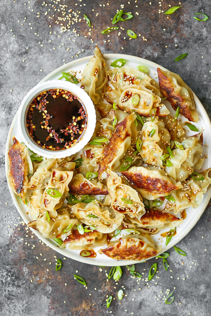 Garlic Ginger Chicken Potstickers - Homemade potstickers are easier to make than you think! Plus, they are cheaper and tastier than take-out or store-bought. Best of all, you can make these ahead of time and freeze so you can have these anytime, anywhere!