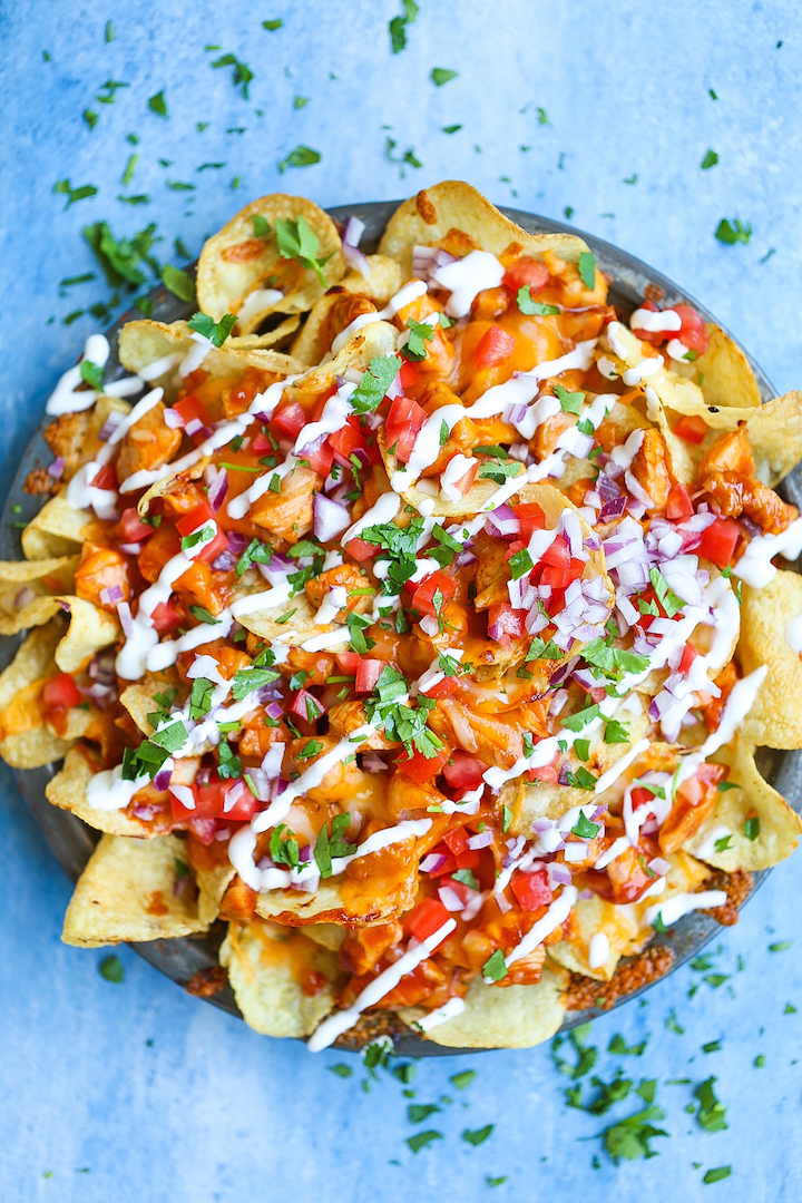 Loaded BBQ Chicken Nachos - Say hello to the best nachos EVER! Loaded with perfectly tender BBQ chicken bites, two types of cheeses, tomatoes, onion, sour cream, cilantro and potato chips! Guaranteed to be a crowd-pleaser. I PROMISE!