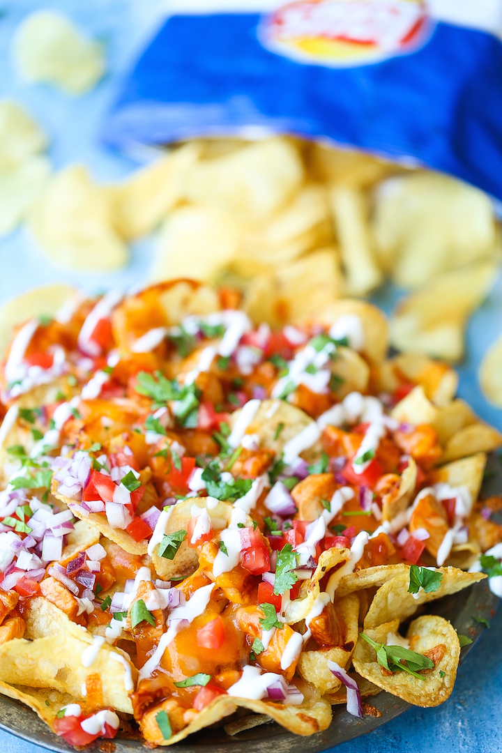 Loaded BBQ Chicken Nachos - Say hello to the best nachos EVER! Loaded with perfectly tender BBQ chicken bites, two types of cheeses, tomatoes, onion, sour cream, cilantro and potato chips! Guaranteed to be a crowd-pleaser. I PROMISE!
