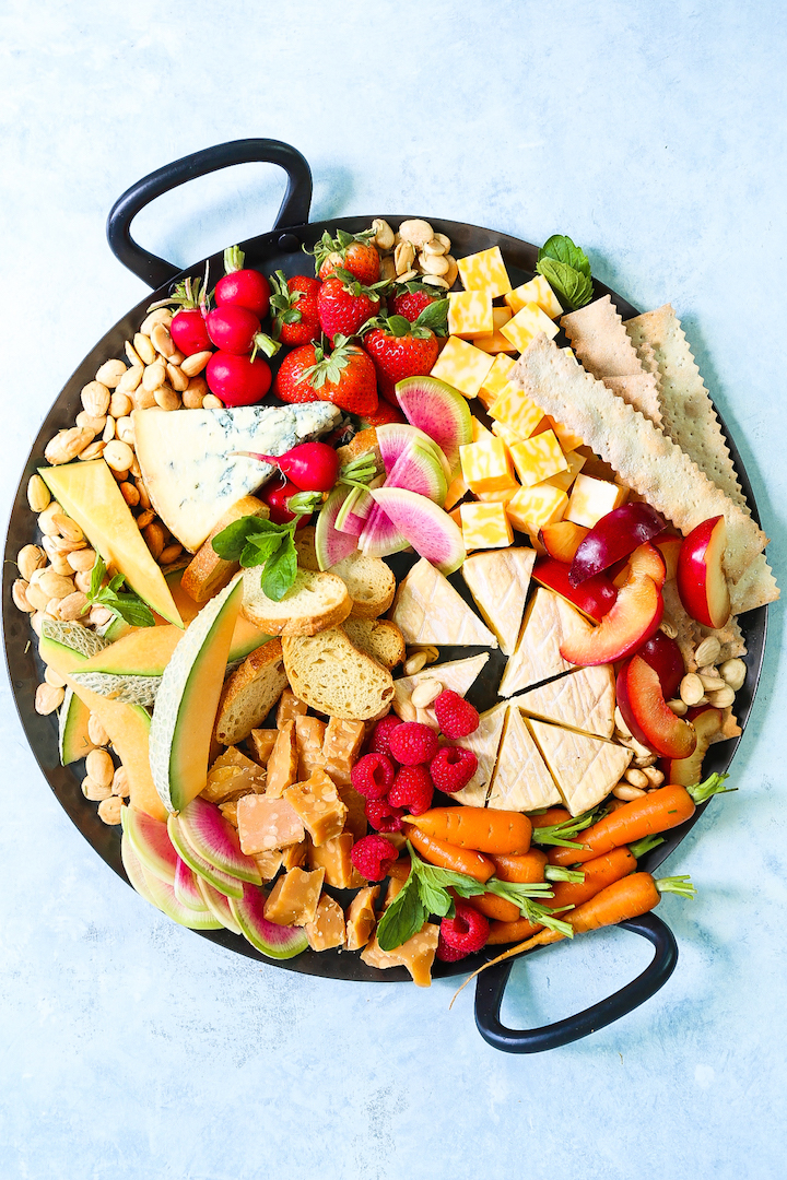 Spring Cheese Board - How to build the most PERFECT cheese board! Perfect for entertaining and impressing your guests, this cheese board is assembled with so many of our favorite Spring fruits and veggies!