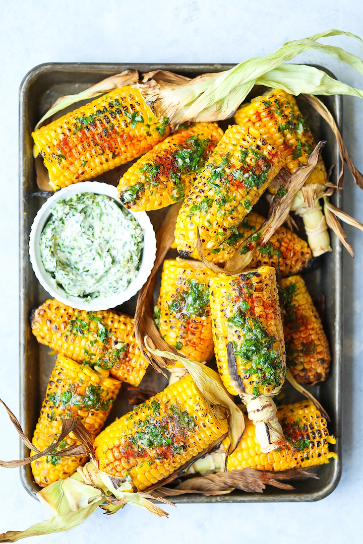 Summer Roasted Garlic Butter Corn - An absolute summer staple! The corn is perfectly sweet and juicy, served with the easiest and most irresistible garlic herb butter! Perfect for summer get-togethers and barbecues!