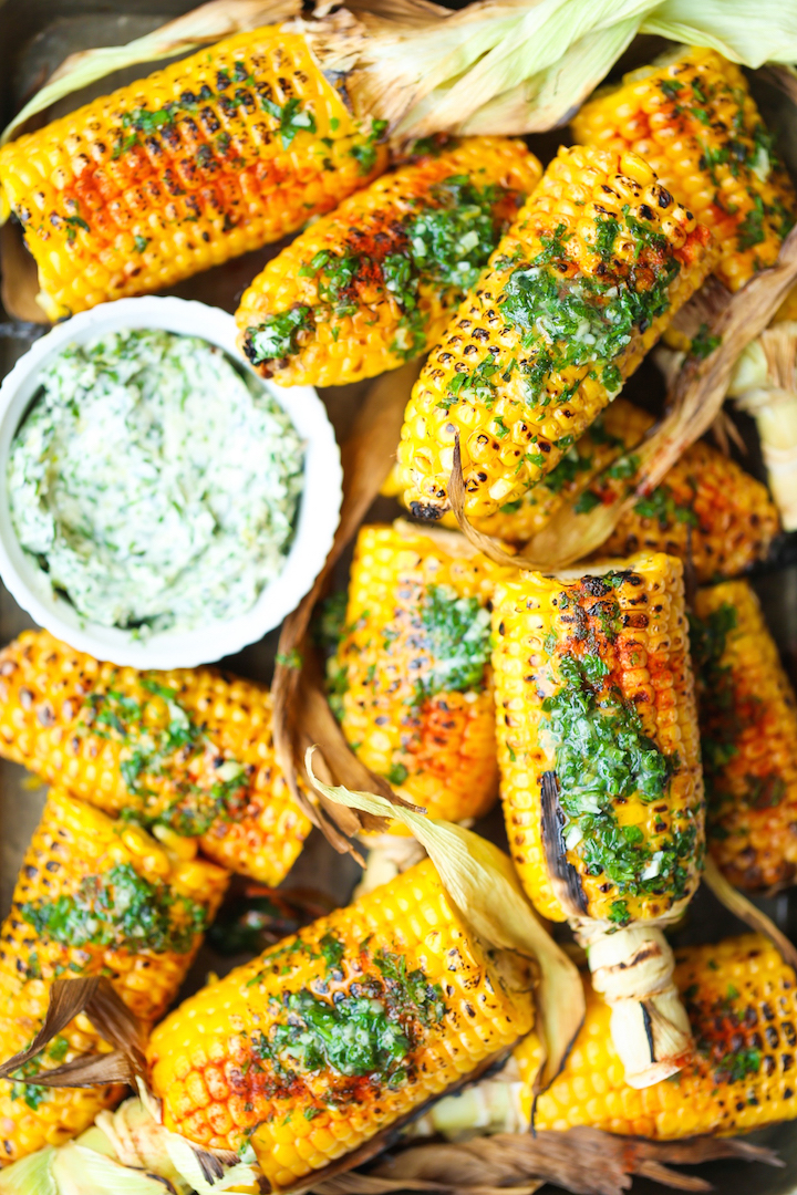 Summer Roasted Garlic Butter Corn - An absolute summer staple! The corn is perfectly sweet and juicy, served with the easiest and most irresistible garlic herb butter! Perfect for summer get-togethers and barbecues!