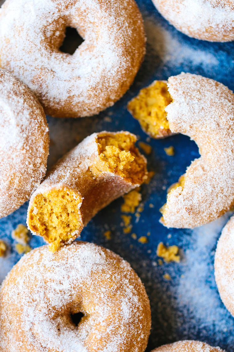Pumpkin Cake Donuts - The MOST HEAVENLY pumpkin donuts! So moist, they just melt-in-your mouth! Coated in melted butter and cinnamon sugar. It's perfection!