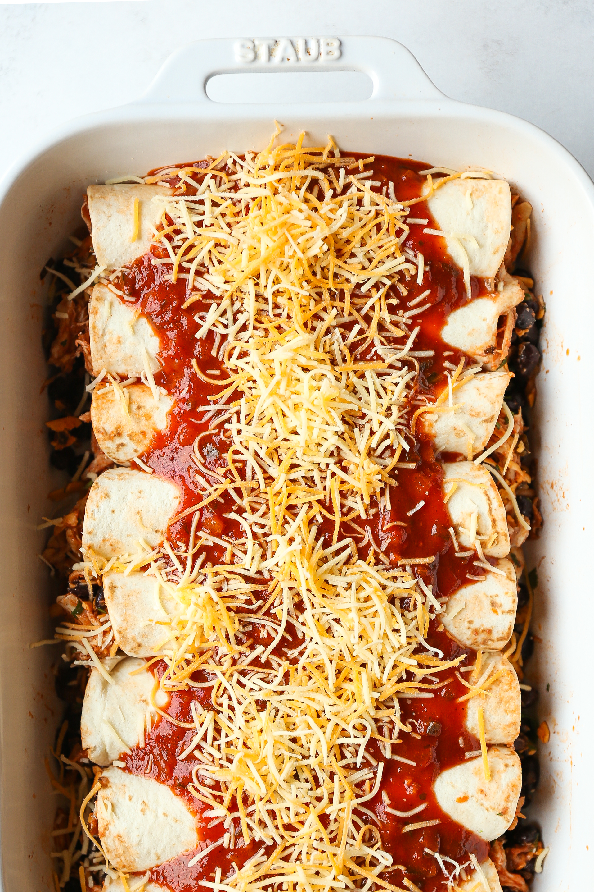 Weeknight Chicken Enchiladas - Classic chicken and black bean enchiladas for those busy weeknights! Easy to assemble with a quick homemade enchilada sauce!