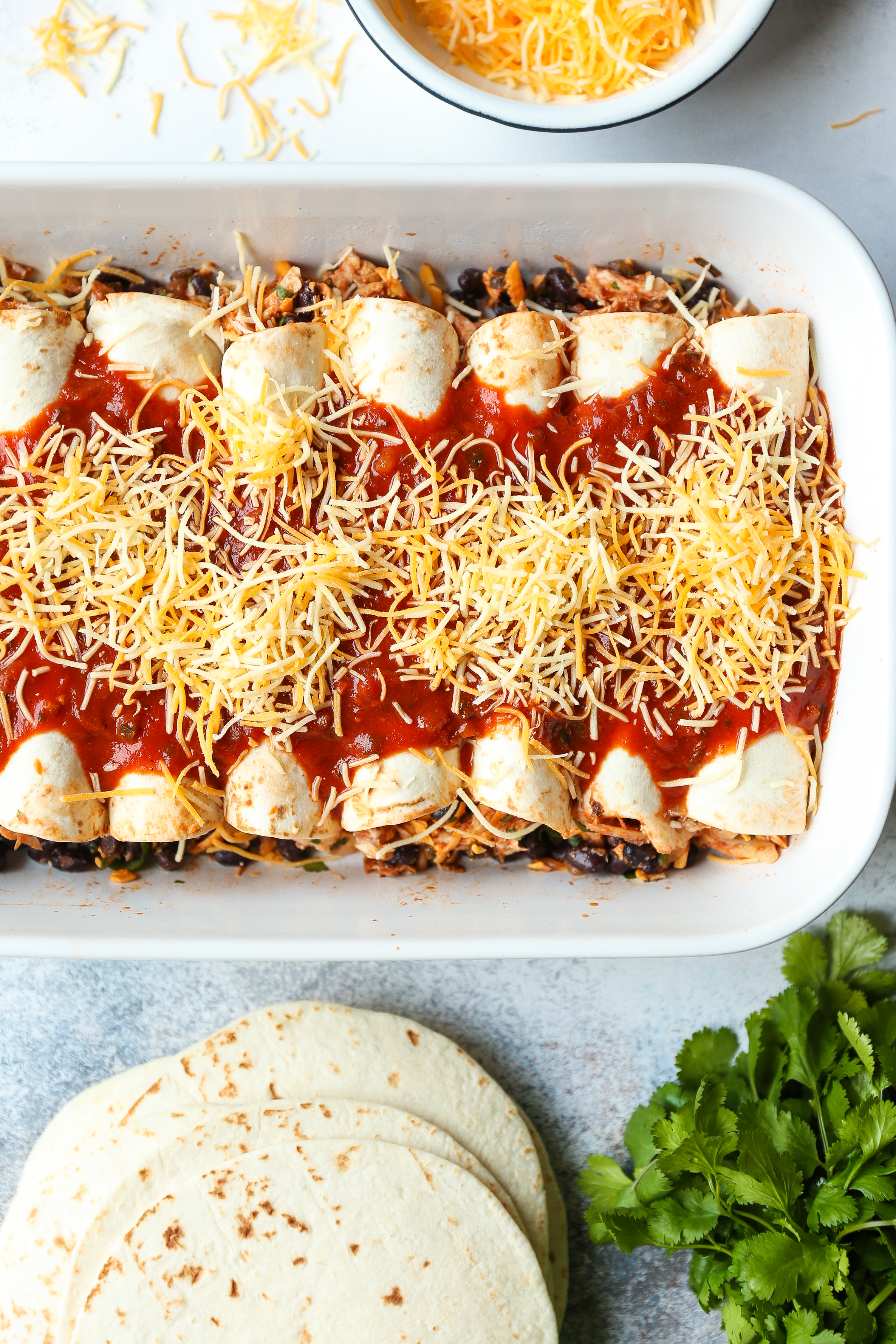 Weeknight Chicken Enchiladas - Classic chicken and black bean enchiladas for those busy weeknights! Easy to assemble with a quick homemade enchilada sauce!