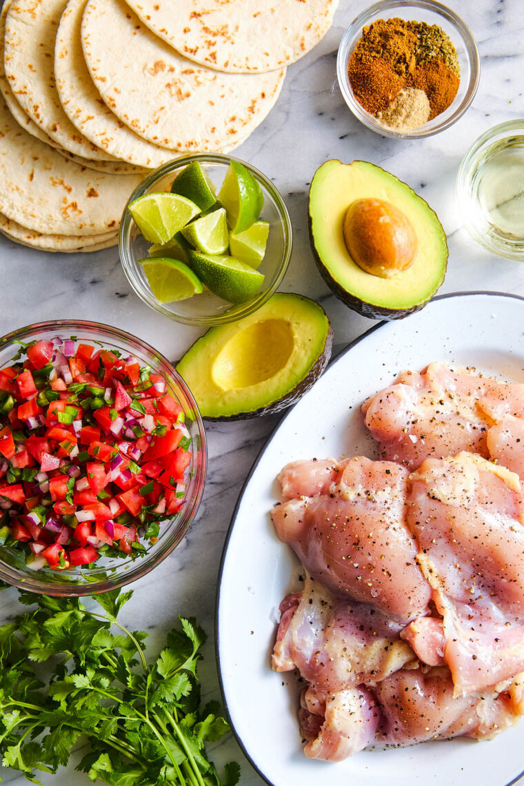 Easy Chicken Tacos - With a simple spice rub, the chicken is cooked quickly on the stovetop! Serve with pico de gallo, avocado + lime wedges!