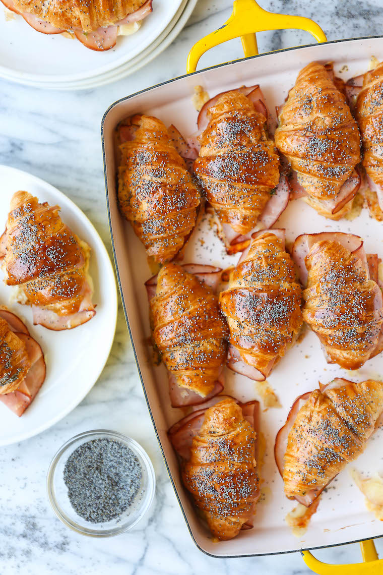 Baked Ham and Cheese Croissants - So so easy to make for a crowd! The mini croissants are toasted and flaky, baked with Dijon-honey, buttery goodness. WHOA.