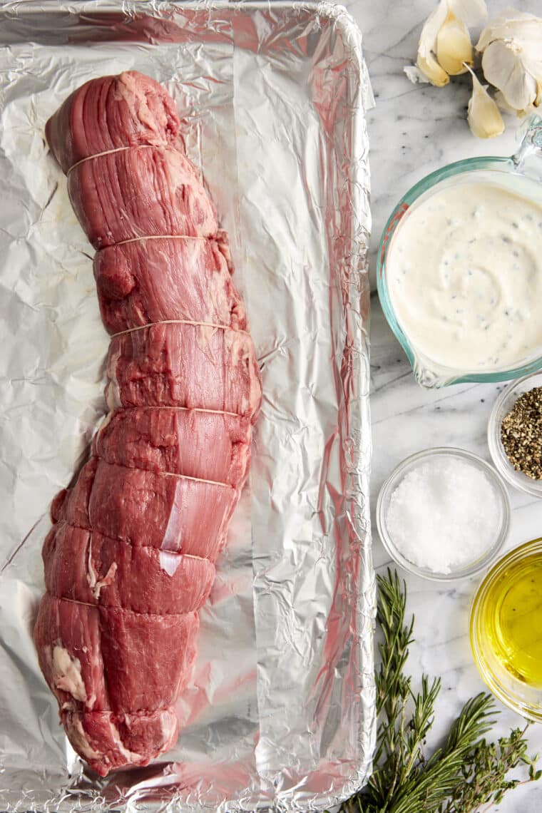 Garlic Rosemary Beef Tenderloin - Cooked low + slow, this is the most perfect (and only way to cook) tenderloin! So easy, so tender, so good.