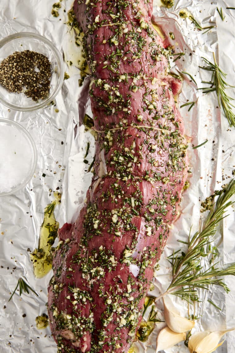 Garlic Rosemary Beef Tenderloin - Cooked low + slow, this is the most perfect (and only way to cook) tenderloin! So easy, so tender, so good.