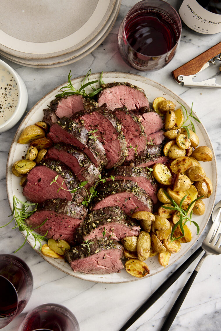 Garlic Rosemary Beef Tenderloin - Cooked low + slow, this is the most perfect (and only way to cook) tenderloin! So easy, so tender, so good.