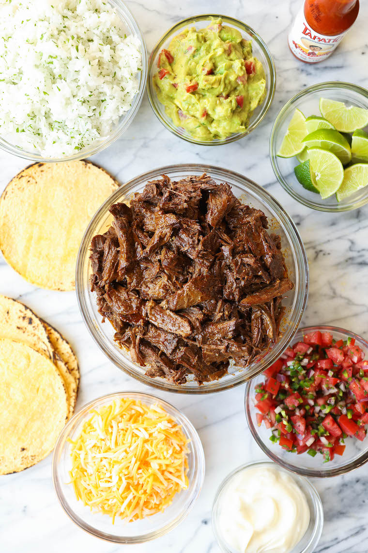 Slow Cooker Beef Barbacoa - So easy and so flavorful! Cooked low + slow in the crockpot. Perfect for tacos, burritos, quesadillas, and more!