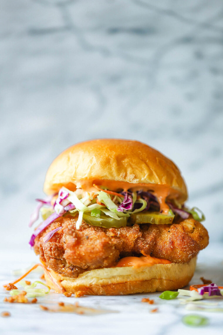 Fried Chicken Sandwiches - KILLER buttermilk fried chicken thighs! So crispy, so juicy. Served with Sriracha mayonnaise, coleslaw and pickles!