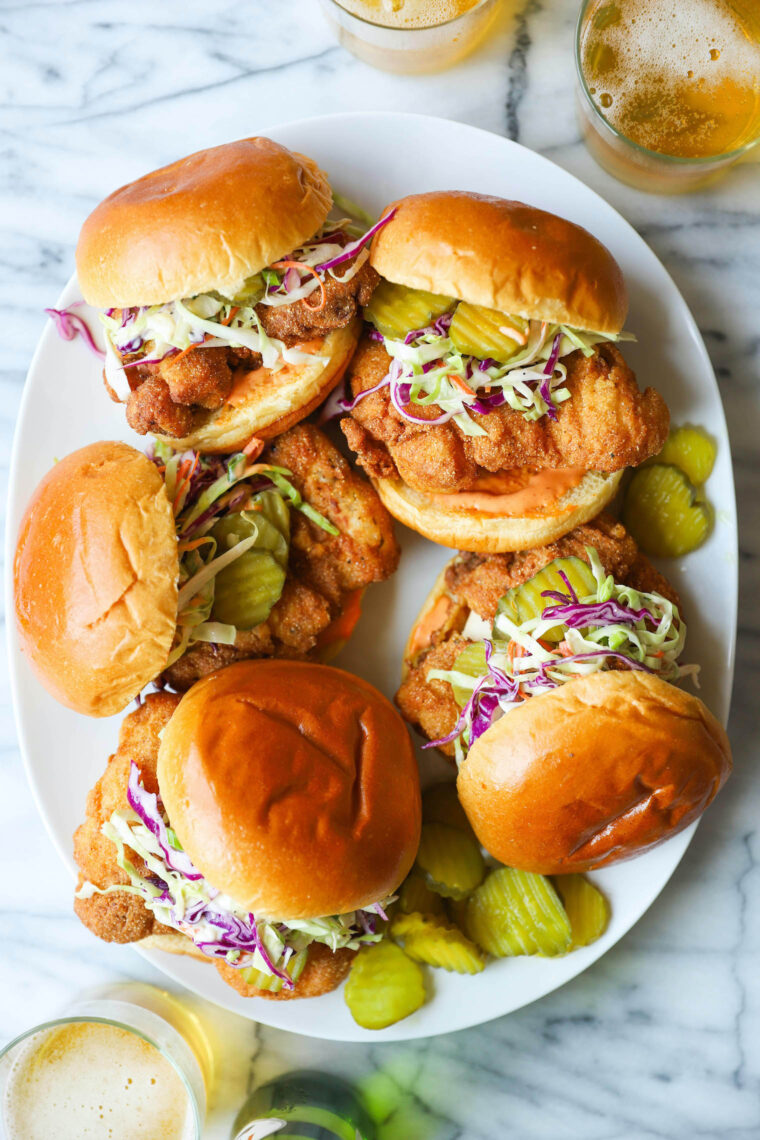 Fried Chicken Sandwiches - KILLER buttermilk fried chicken thighs! So crispy, so juicy. Served with Sriracha mayonnaise, coleslaw and pickles!