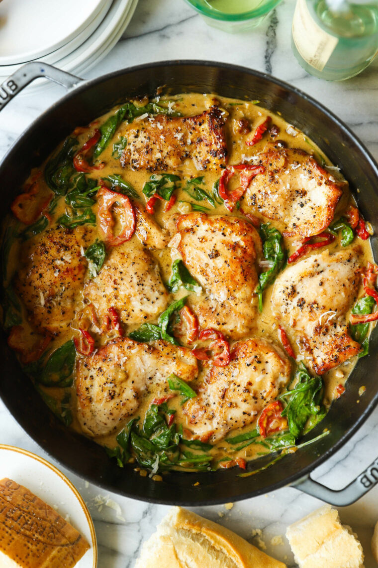 Skillet Sun Dried Tomato Chicken Thighs - Juicy, golden brown chicken in the sauciest, sun dried tomato cream sauce with sneaked-in greens!