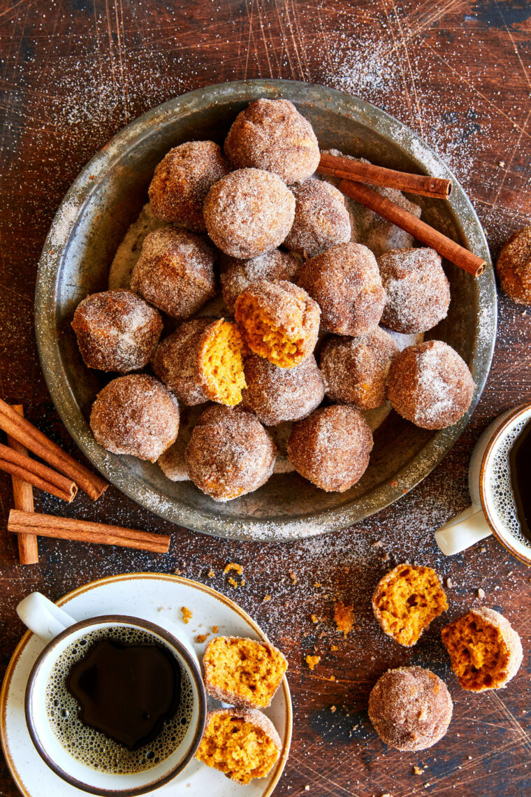 Pumpkin Donut Holes - The most irresistible mini pumpkin muffins smothered in cinnamon sugar goodness! Perfect for breakfast, lunch + dinner! 