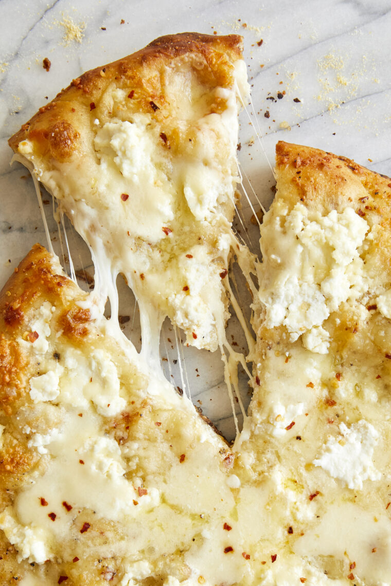 White Pizza - Made with 3 different cheeses (no tomato sauce here!) and drizzled with extra-virgin olive oil, garlicky goodness. Yes, please!
